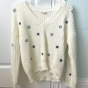 White knitted sweater with black stars